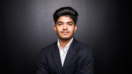 indian business man on dark background, crossed arm